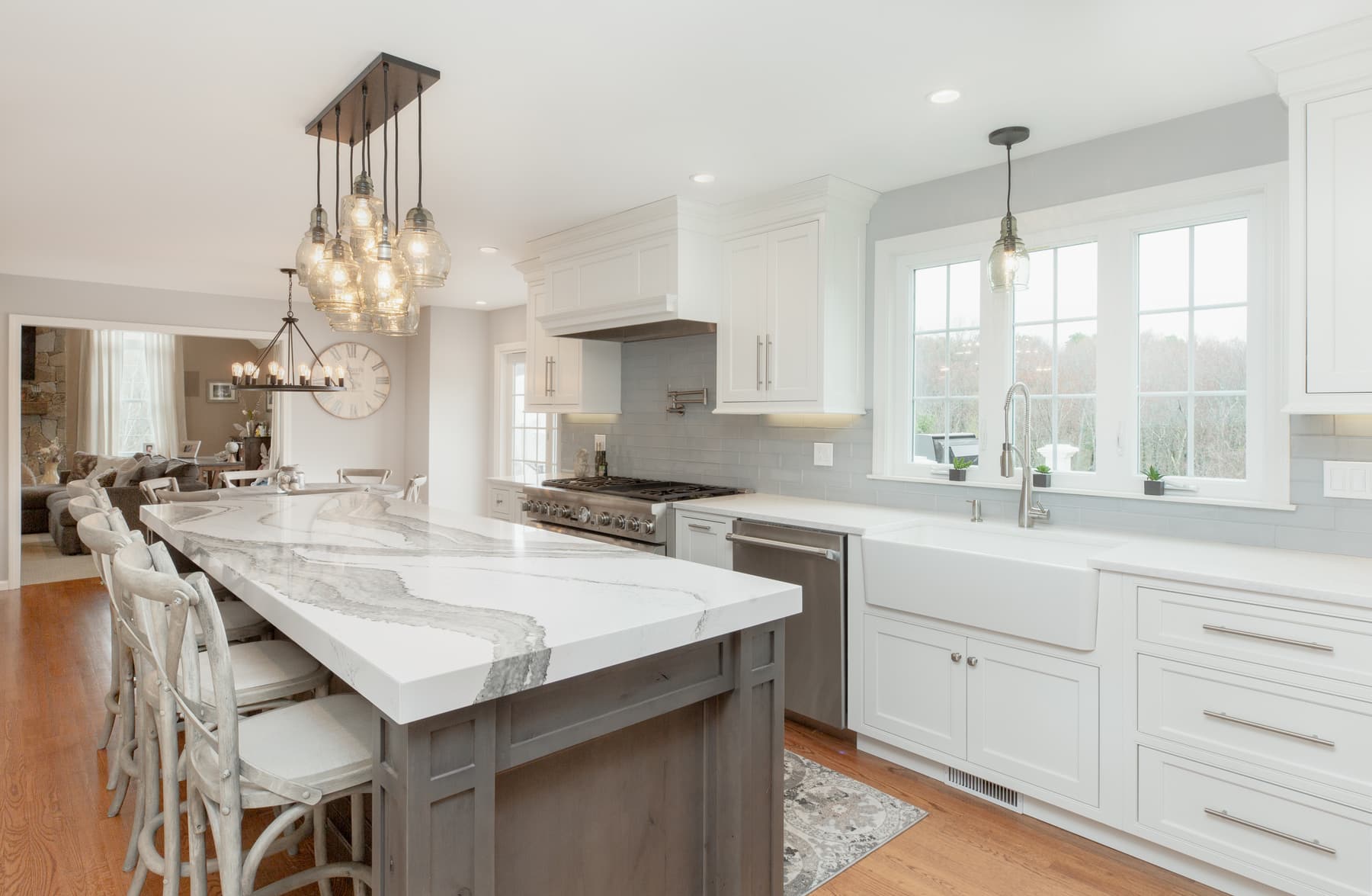 White kitchen cabinetry and a dark island in a Methuen, Massachusetts home